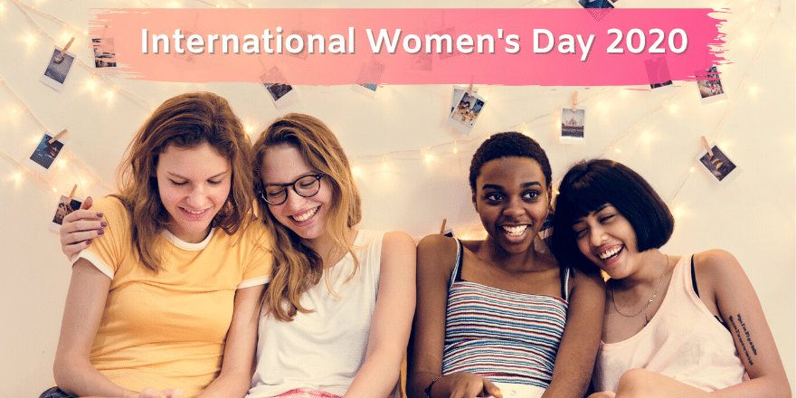 Four young women smile and laugh together on International Women's Day, 2020.