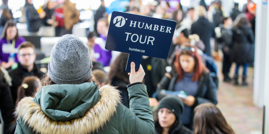 A first year student of Humber College guides a campus tour, and her participants, thanks to this survival guide, feel right at home!